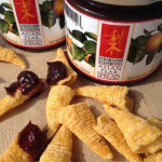 corn bugle dipped into open jar of Asian Pear spread, nested in a pile of bugles